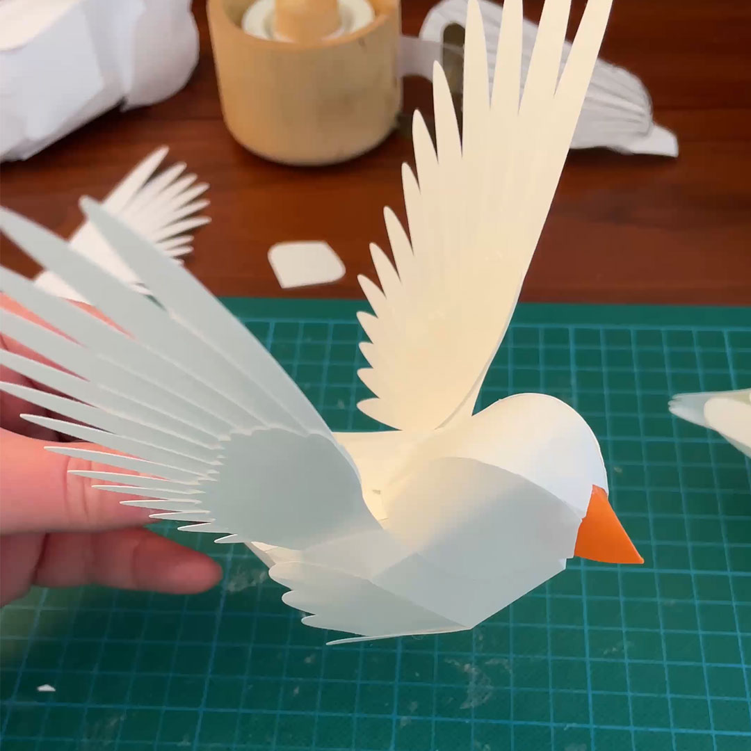 Paper birds in production by Helen Friel, capturing the creative process